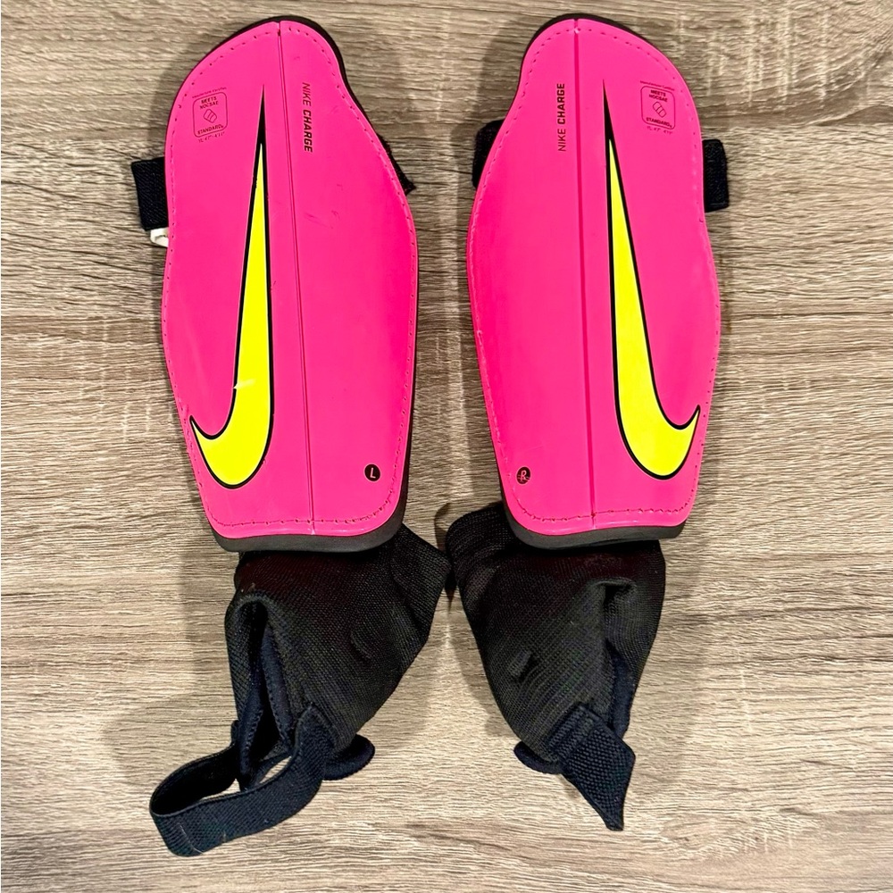 Nike charge youth size large shin guard. Pink yellow black. Gently used